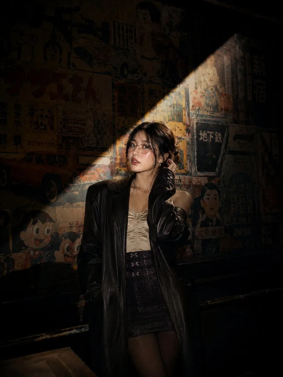 Cinematic nighttime portrait of a stylish young Asian wom...