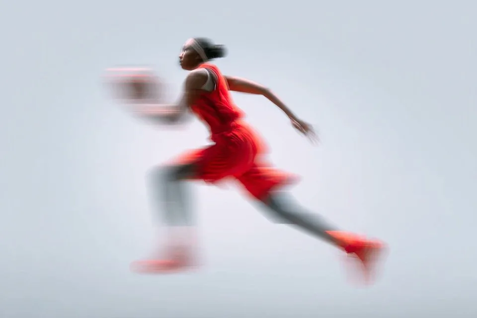 A blurred silhouette of a [Subject] in motion, wearing a ...