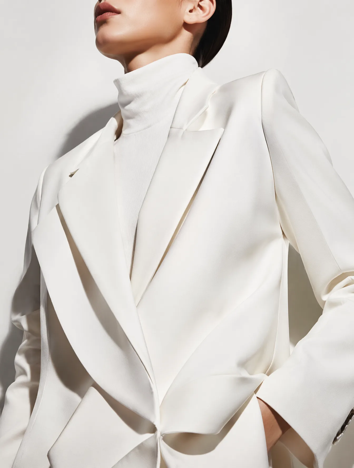 A sophisticated editorial portrait of a model wearing an ...