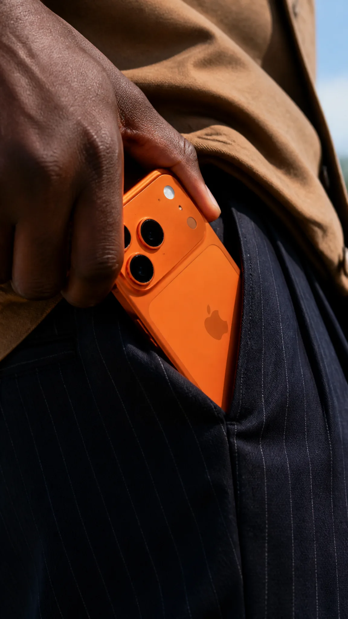 A close-up shot shows a person's dark-skinned hand, likel...